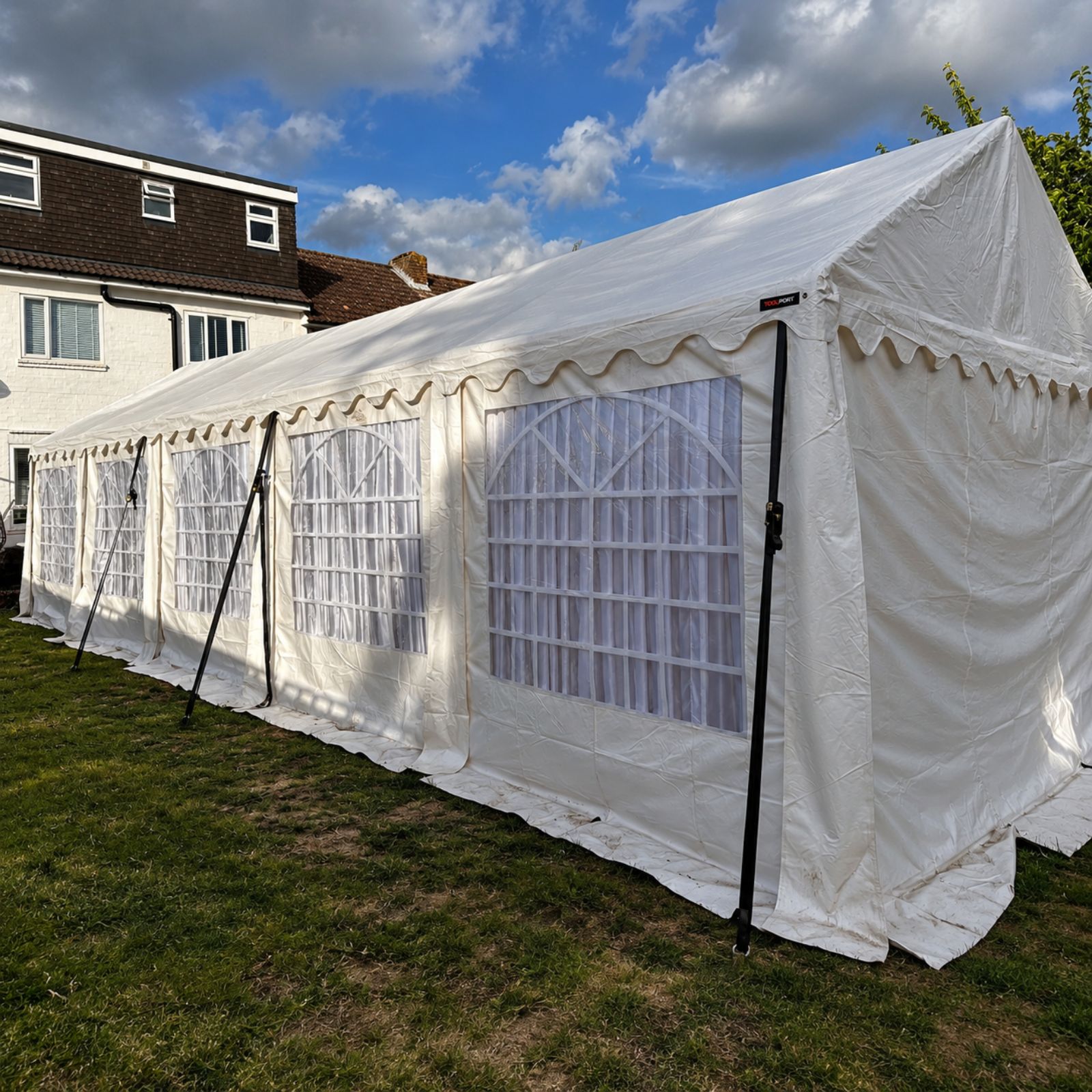 White event marquee set up on a lawn.