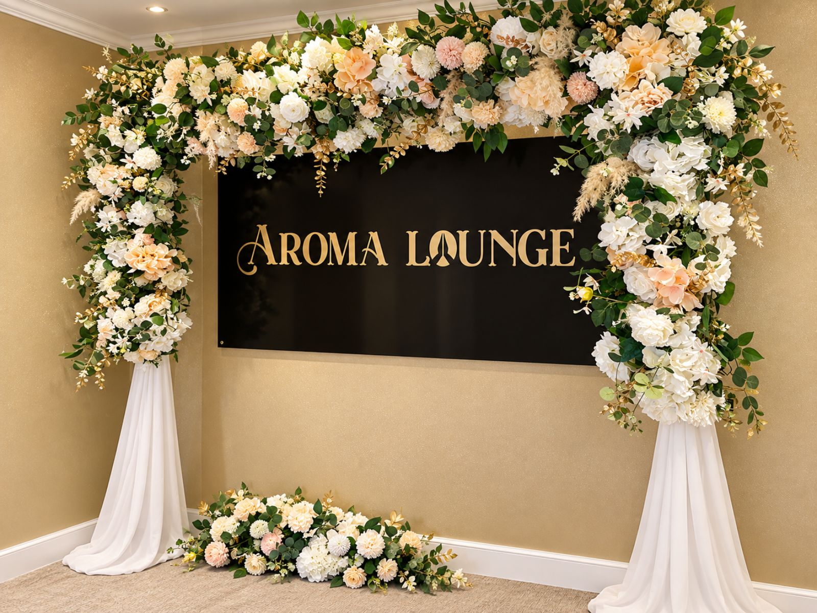 White floral entrance styling around a business sign.
